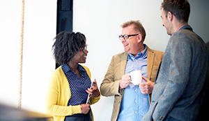 Young black woman speaking to an older gentleman 