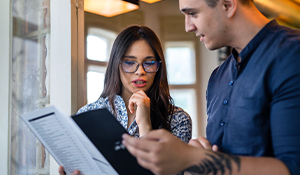A women and a man reviewing a booklet