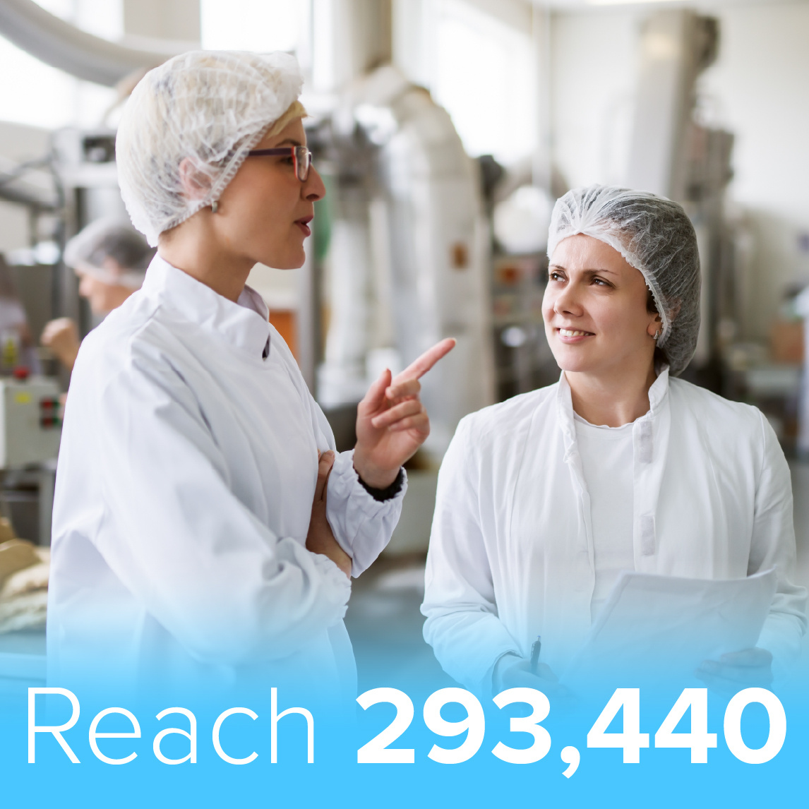 Two food processing professionals wearing white lab coats and hairnets discuss operations in a food manufacturing facility. One gestures while speaking, and the other listens attentively. Industrial equipment is visible in the background. A blue banner at the bottom displays the text 