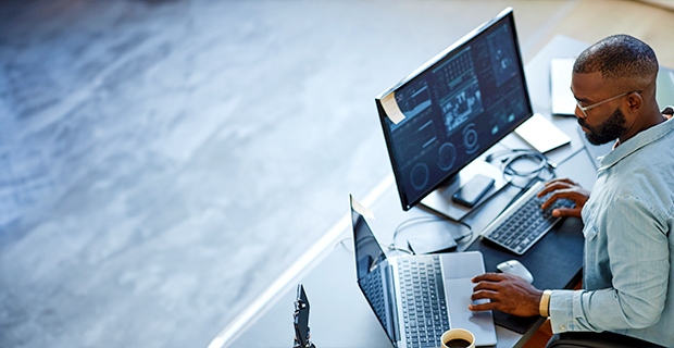 Man sitting at a computer analyzing data