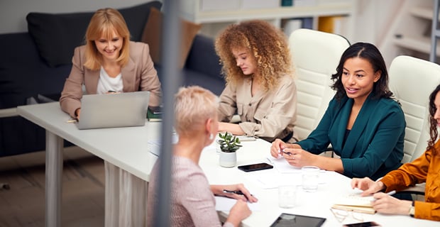 Corporate women sitting at a conference table 